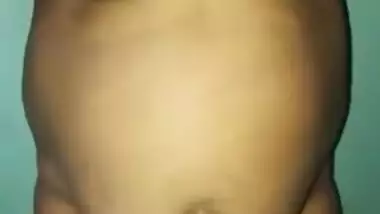 Desi woman with sexy fat tummy and big tits spreads pussy in XXX video