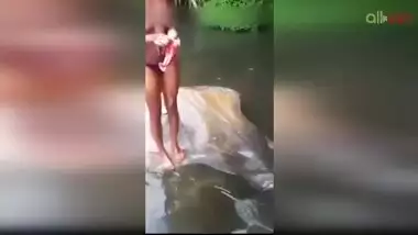 Lewd amateur Desi aunty flashing her nice big tits while bathing outdoor
