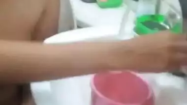 Desi female sits on a toilet bowl with naked XXX boobies and pussy